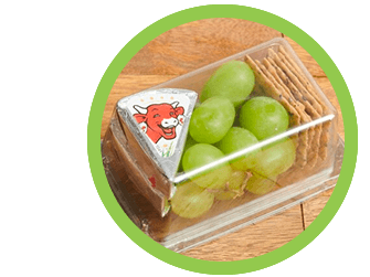 Wedge of The Laughing Cow Original cheese with grapes and rice crackers