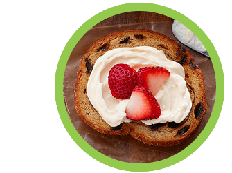 The Laughing Cow Creamy Light cheese spread on raisin bread with strawberries