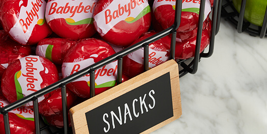 Babybel snack cheese wheels in a basket marked "Snacks"